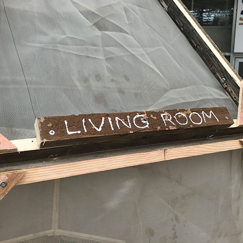 Detail of the sign above the door reading Living Room